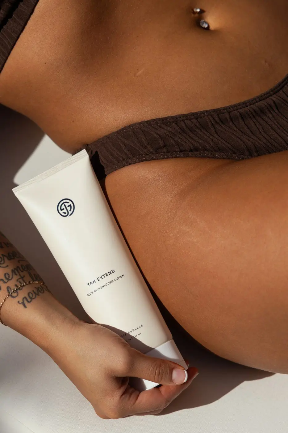 Sjolie Tan Extend Glow Replenishing Lotion tube closeup with DHA bronzer-free formula