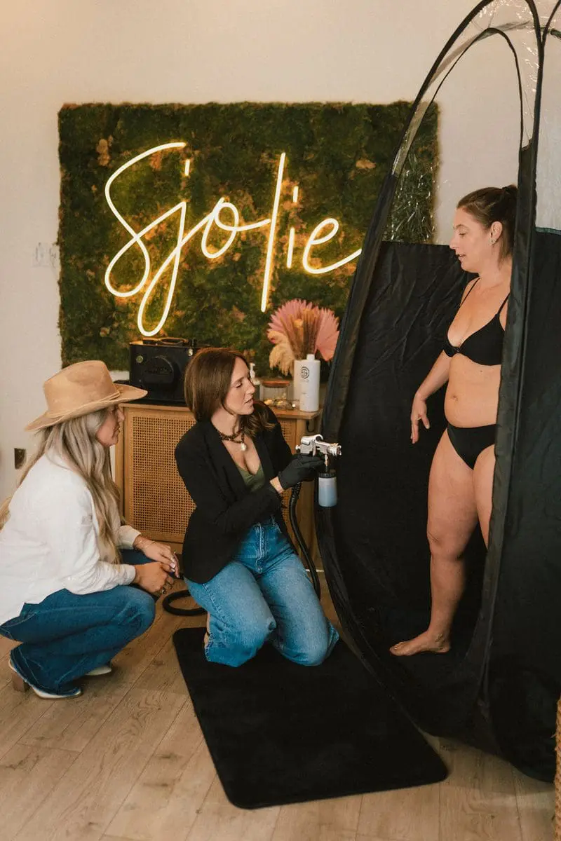 Professional spray tan studio setup with Sjolie products