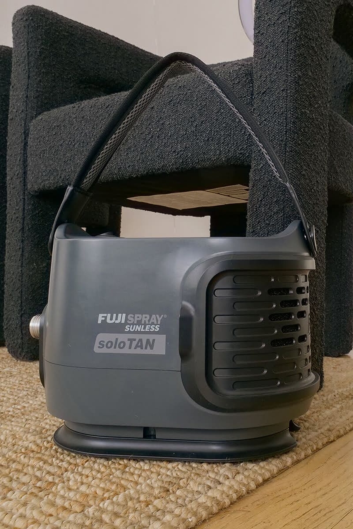 Fuji soloTAN Turbine spray tan machine in gray on a woven rug