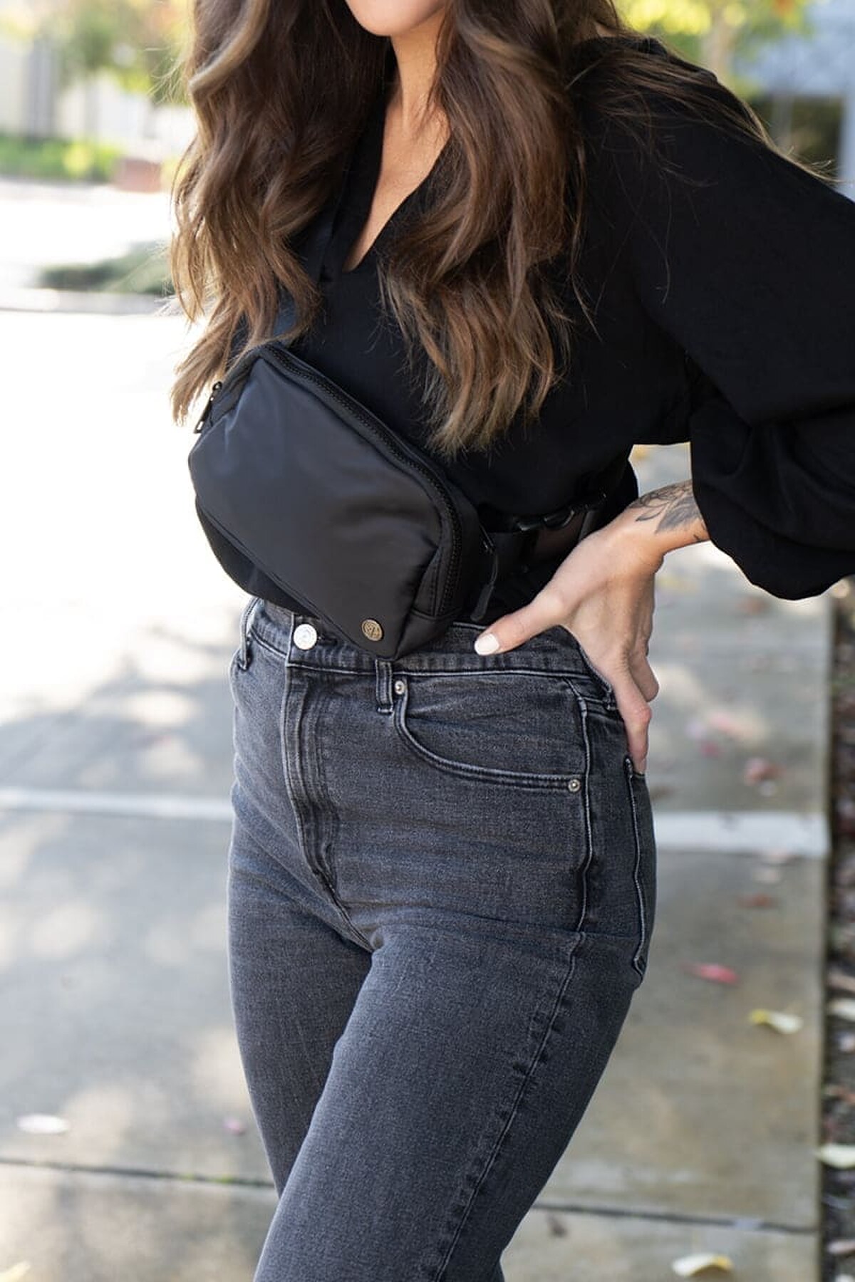 Model wearing the black SJOLIE Logo Shoulder Bag across her body