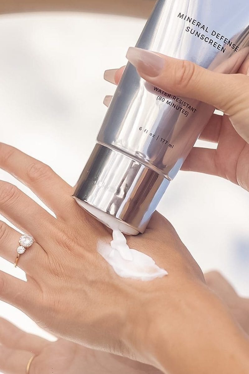 SJOLIE Mineral Defense Sunscreen squeezed onto the back of a hand