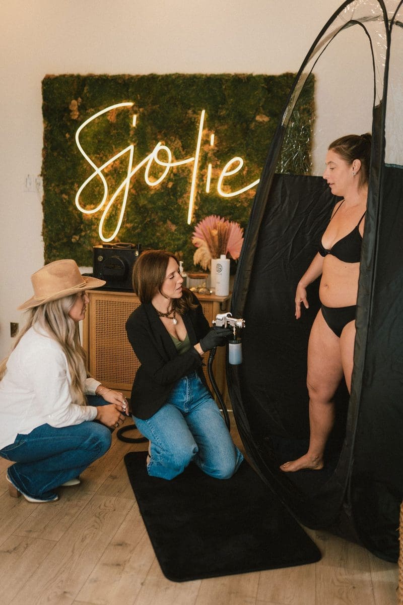 Professional spray tan studio setup with Sjolie products and equipment