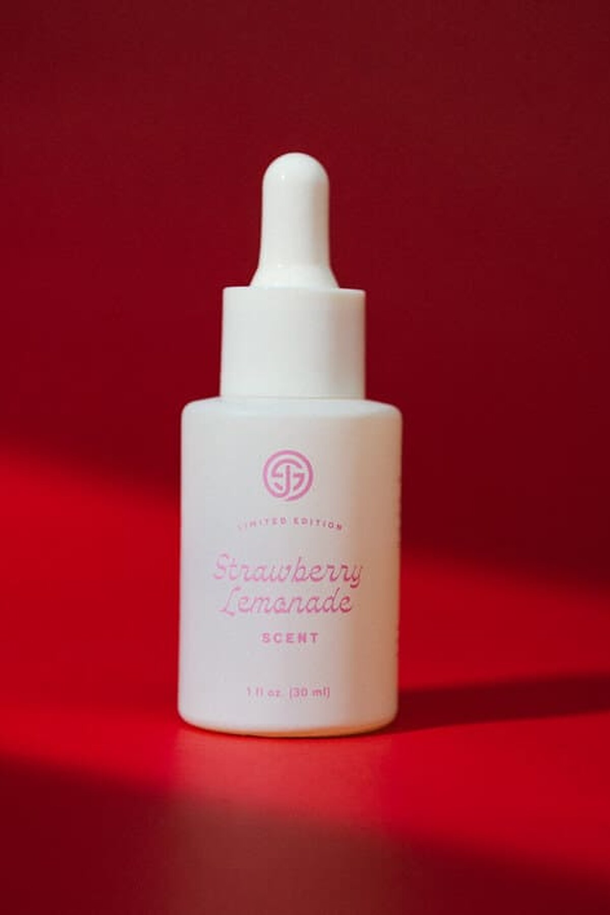 SJOLIE Strawberry Lemonade Scent dropper bottle on a red background