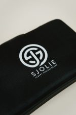 Detail of the Sjolie Luxury Sunless Brand logo on the wireless kit carrying case