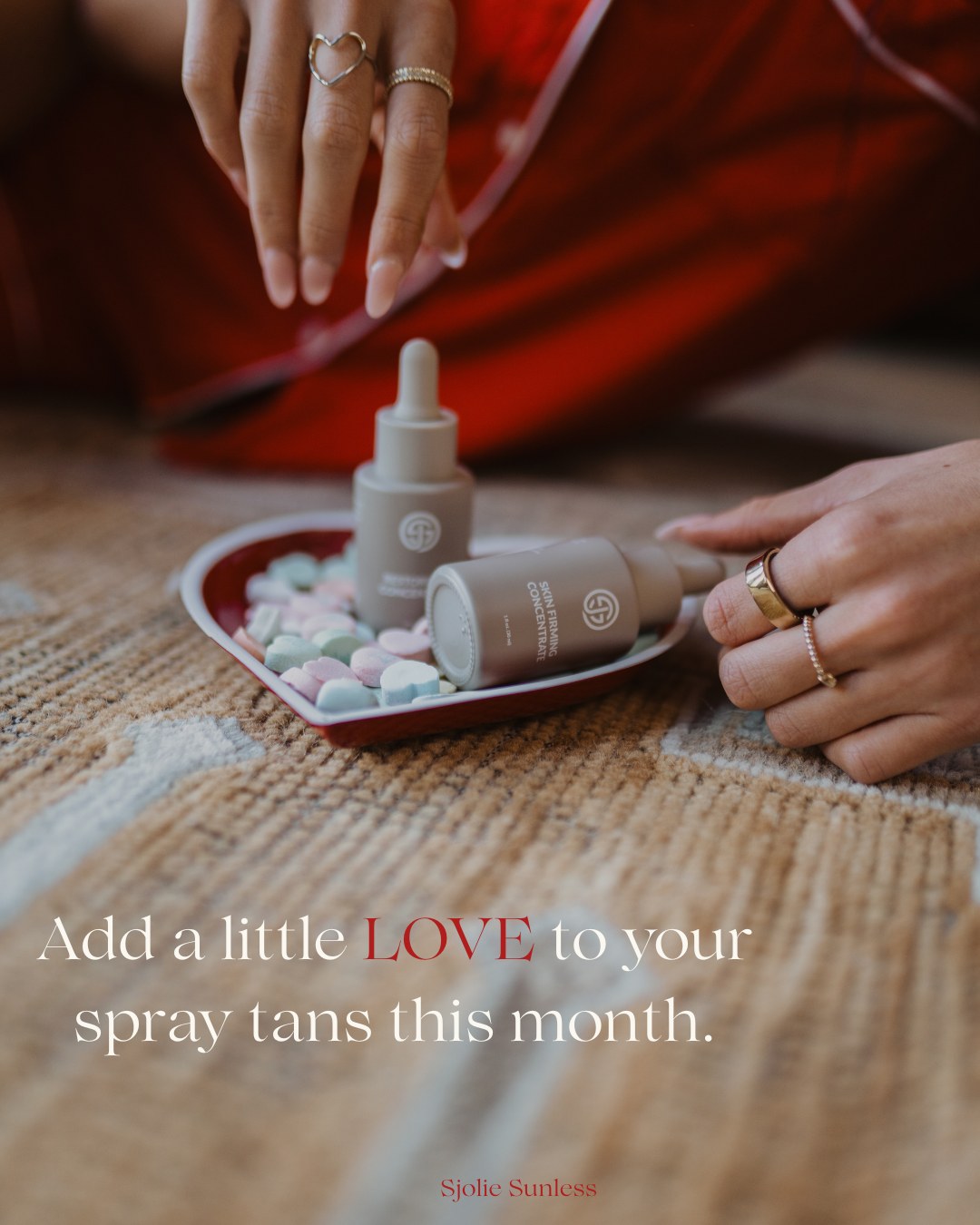 Sjolie Skin Firming Additive — Skin Firming Concentrate and second additive bottle on heart-shaped candy tray add-a-little-love ad for spray tan professionals