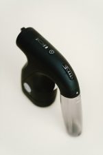 Top view of the Sjolie wireless spray tan gun showing power button and settings controls